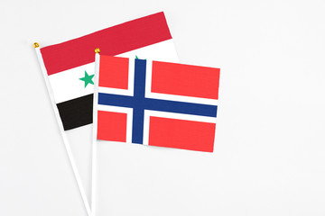 Bouvet Islands and Syria stick flags on white background. High quality fabric, miniature national...