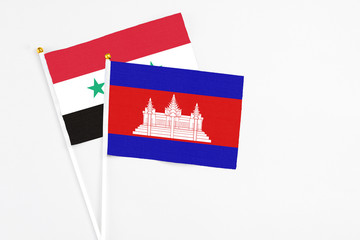 Cambodia and Syria stick flags on white background. High quality fabric, miniature national flag....