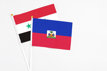 Haiti and Syria stick flags on white background. High quality fabric, miniature national flag....