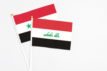 Iraq and Syria stick flags on white background. High quality fabric, miniature national flag. Peaceful global concept.White floor for copy space.