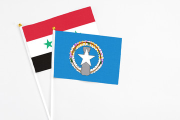 Northern Mariana Islands and Syria stick flags on white background. High quality fabric, miniature...