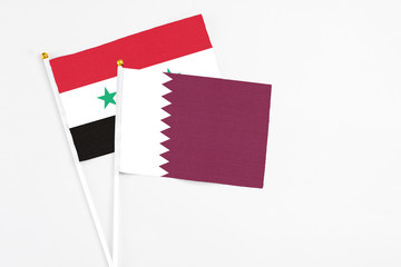 Qatar and Syria stick flags on white background. High quality fabric, miniature national flag....