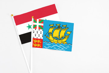 Saint Pierre And Miquelon and Syria stick flags on white background. High quality fabric, miniature...