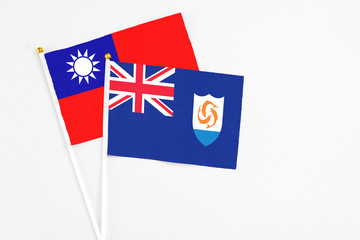 Fototapeta premium Anguilla and Taiwan stick flags on white background. High quality fabric, miniature national flag. Peaceful global concept.White floor for copy space.