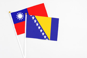Bosnia Herzegovina and Taiwan stick flags on white background. High quality fabric, miniature national flag. Peaceful global concept.White floor for copy space.