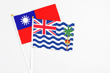 Fototapeta premium British Indian Ocean Territory and Taiwan stick flags on white background. High quality fabric, miniature national flag. Peaceful global concept.White floor for copy space.