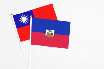 Haiti and Taiwan stick flags on white background. High quality fabric, miniature national flag....