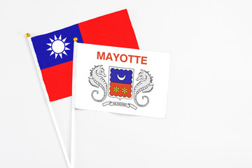 Mayotte and Taiwan stick flags on white background. High quality fabric, miniature national flag. Peaceful global concept.White floor for copy space.