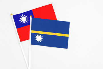 Nauru and Taiwan stick flags on white background. High quality fabric, miniature national flag....