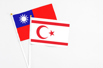 Northern Cyprus and Taiwan stick flags on white background. High quality fabric, miniature national flag. Peaceful global concept.White floor for copy space.