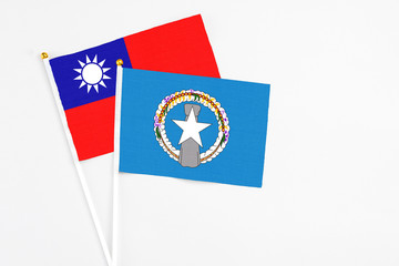 Northern Mariana Islands and Taiwan stick flags on white background. High quality fabric, miniature national flag. Peaceful global concept.White floor for copy space.