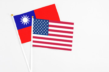 United States and Taiwan stick flags on white background. High quality fabric, miniature national flag. Peaceful global concept.White floor for copy space.