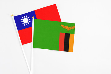 Zambia and Taiwan stick flags on white background. High quality fabric, miniature national flag. Peaceful global concept.White floor for copy space.