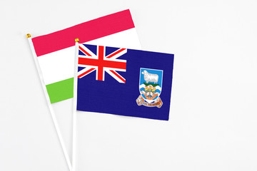 Falkland Islands and Tajikistan stick flags on white background. High quality fabric, miniature...