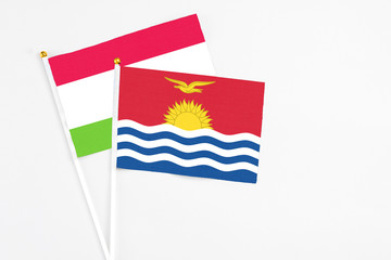 Kiribati and Tajikistan stick flags on white background. High quality fabric, miniature national flag. Peaceful global concept.White floor for copy space.