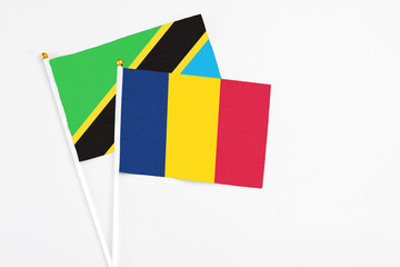 Chad and Tanzania stick flags on white background. High quality fabric, miniature national flag. Peaceful global concept.White floor for copy space.