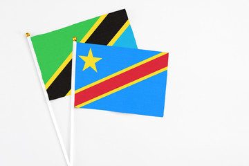 Congo and Tanzania stick flags on white background. High quality fabric, miniature national flag. Peaceful global concept.White floor for copy space.