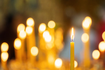 Candle light in christian church warm tone with dark black background
