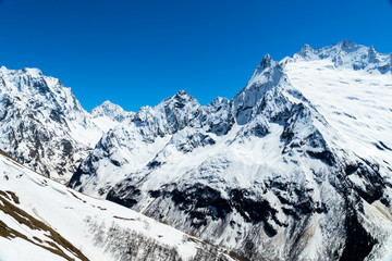 Naklejka premium Caucasus mountains - The highest mountains in Russia. Snow mountains with blue sky background