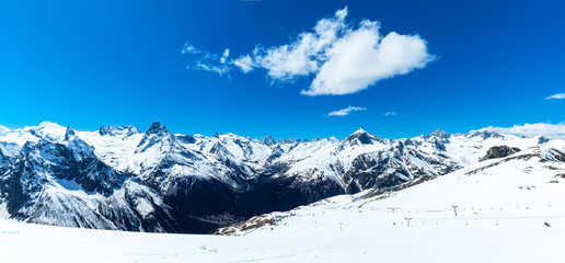 Caucasus mountains - The highest mountains in Russia. Snow mountains with blue sky background. Panorama