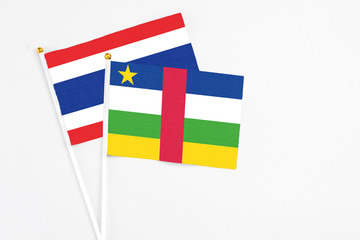 Fototapeta premium Central African Republic and Thailand stick flags on white background. High quality fabric, miniature national flag. Peaceful global concept.White floor for copy space.