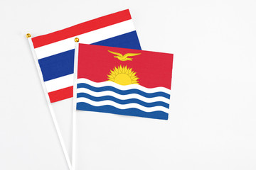Kiribati and Thailand stick flags on white background. High quality fabric, miniature national flag. Peaceful global concept.White floor for copy space.