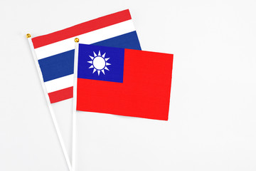 Taiwan and Thailand stick flags on white background. High quality fabric, miniature national flag. Peaceful global concept.White floor for copy space.
