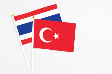 Turkey and Thailand stick flags on white background. High quality fabric, miniature national flag. Peaceful global concept.White floor for copy space.
