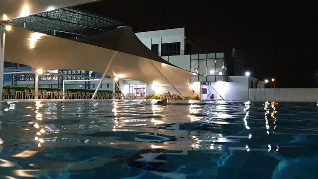 Close up water surface of swimming pool in the night