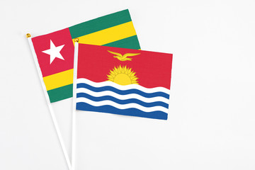 Kiribati and Togo stick flags on white background. High quality fabric, miniature national flag. Peaceful global concept.White floor for copy space.