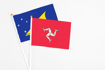 Isle Of Man and Tokelau stick flags on white background. High quality fabric, miniature national...