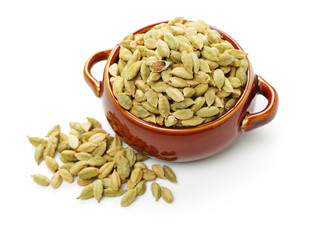 Green cardamom pods on white background