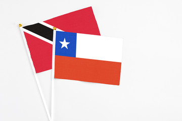 Chile and Trinidad And Tobago stick flags on white background. High quality fabric, miniature national flag. Peaceful global concept.White floor for copy space.