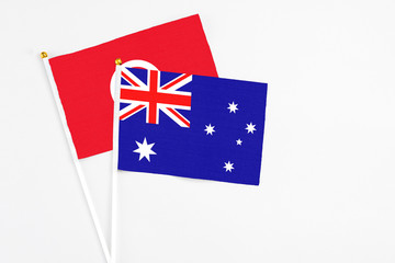 Fototapeta premium Australia and Tunisia stick flags on white background. High quality fabric, miniature national flag. Peaceful global concept.White floor for copy space.