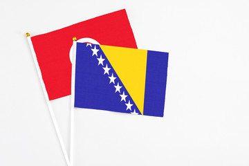 Bosnia Herzegovina and Tunisia stick flags on white background. High quality fabric, miniature...