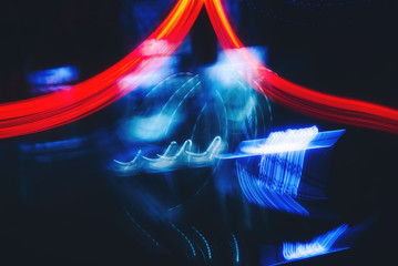 Abstract neon colour light motion over dark background. Slow shutter speed.