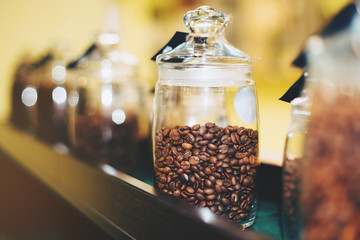 Glass jar with coffee beans in coffeshop