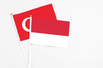 Monaco and Turkey stick flags on white background. High quality fabric, miniature national flag. Peaceful global concept.White floor for copy space.