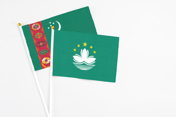 Macao and Turkmenistan stick flags on white background. High quality fabric, miniature national...