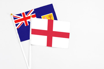 Fototapeta premium England and Turks And Caicos Islands stick flags on white background. High quality fabric, miniature national flag. Peaceful global concept.White floor for copy space.