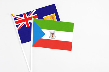 Equatorial Guinea and Turks And Caicos Islands stick flags on white background. High quality fabric, miniature national flag. Peaceful global concept.White floor for copy space.
