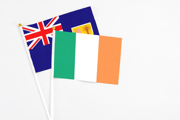 Ireland and Turks And Caicos Islands stick flags on white background. High quality fabric, miniature national flag. Peaceful global concept.White floor for copy space.