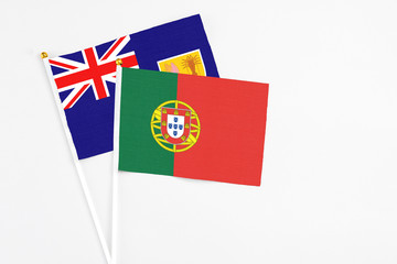 Portugal and Turks And Caicos Islands stick flags on white background. High quality fabric, miniature national flag. Peaceful global concept.White floor for copy space.