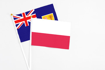 Poland and Turks And Caicos Islands stick flags on white background. High quality fabric, miniature national flag. Peaceful global concept.White floor for copy space.