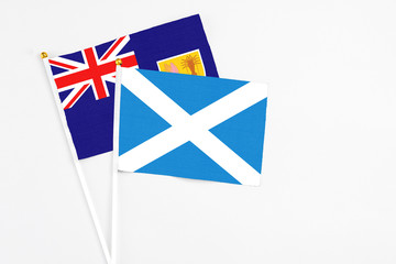 Scotland and Turks And Caicos Islands stick flags on white background. High quality fabric, miniature national flag. Peaceful global concept.White floor for copy space.