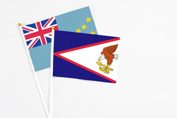 American Samoa and Tuvalu stick flags on white background. High quality fabric, miniature national flag. Peaceful global concept.White floor for copy space.