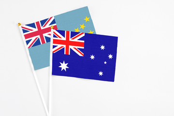 Australia and Tuvalu stick flags on white background. High quality fabric, miniature national flag. Peaceful global concept.White floor for copy space.