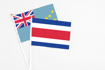 Costa Rica and Tuvalu stick flags on white background. High quality fabric, miniature national flag. Peaceful global concept.White floor for copy space.