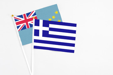 Greece and Tuvalu stick flags on white background. High quality fabric, miniature national flag. Peaceful global concept.White floor for copy space.