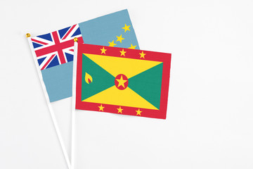 Grenada and Tuvalu stick flags on white background. High quality fabric, miniature national flag....